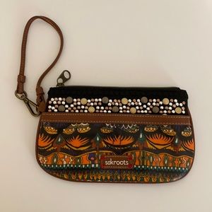 Sakroots wristlet clutch with zipper and a front pocket.